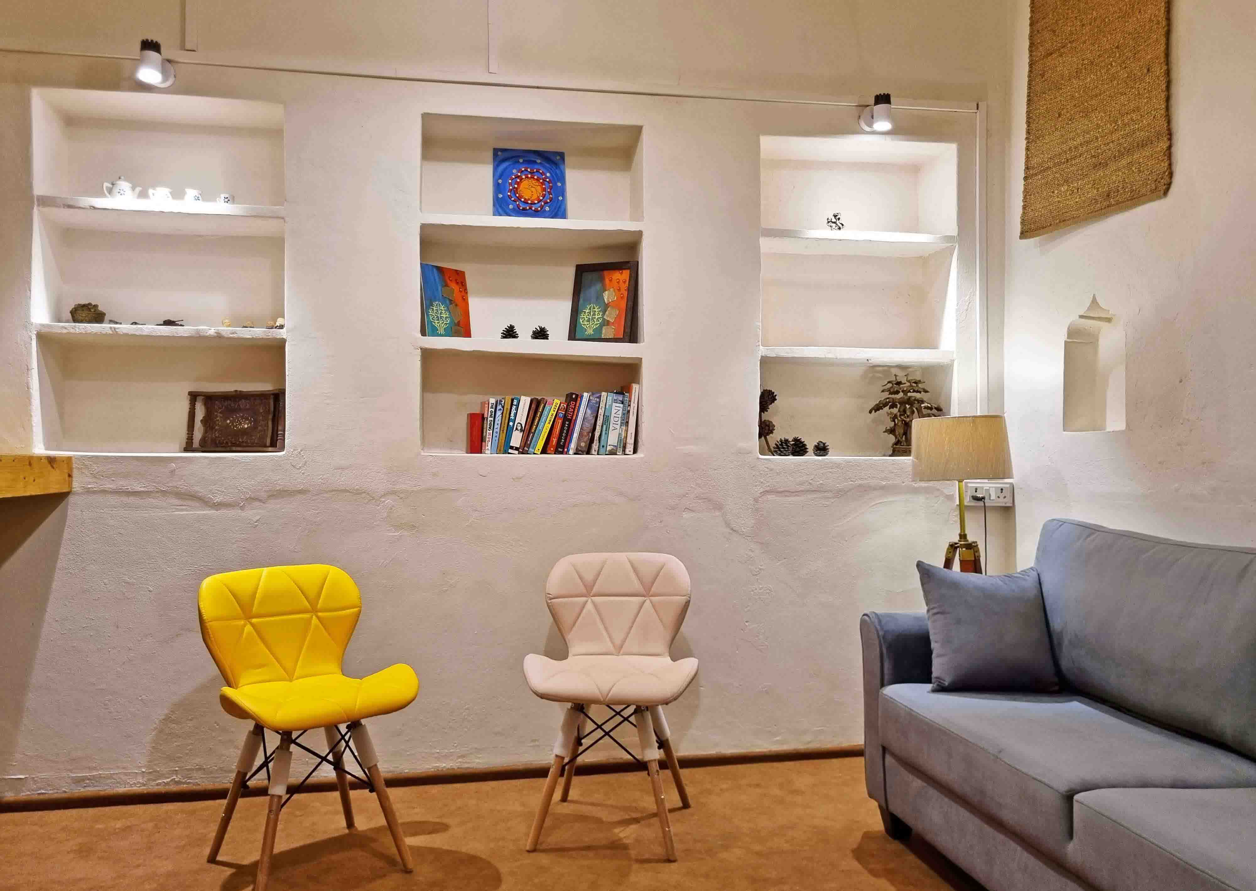 Vintage homestay courtyard showing sofa and chairs with warm lighting and homely vibes